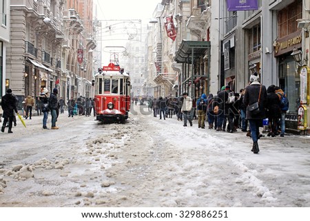 ISTANBUL,TURKEY-FEBRUARY 18: Unidentified pedestrians walk down Istiklal Street on a snowy day on February 18, 2015 in Istanbul, Turkey.Istiklal Street is one of the popular destinations in Istanbul.