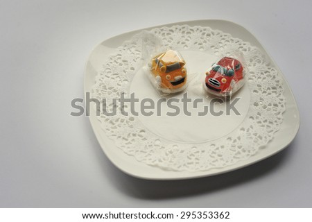 sweet candies of two cars food isolated on white
