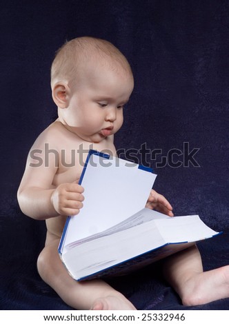 Child sits with book on turn blue background