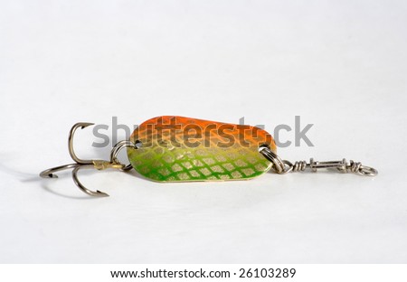 Spoon bait is dyed green colour with hook on white background