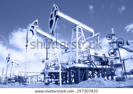 Pump jack and wellhead with valve armature. Extraction of oil.