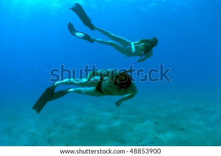 Young girl and man exploring the undersea world