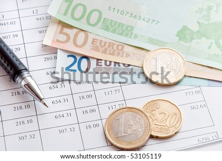 Financial data, euro money and pen. closeup.