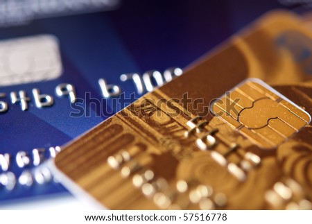 two credit cards, blue and gold, narrow focus. closeup.