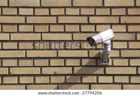 Surveillance camera on a brick wall
