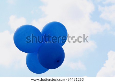 Four blue balloons in the sky