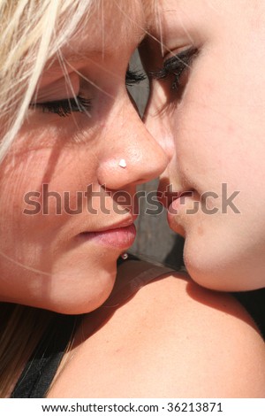stock photo Two girls kissing in the sun