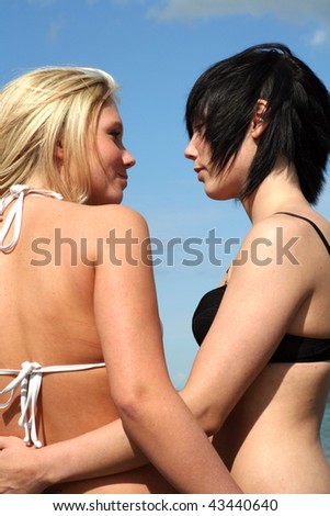 Two young women flirting at the beach
