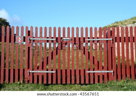 red wooden fence with a gate
