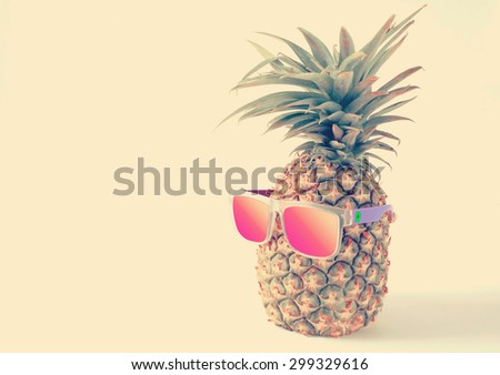 pineapple in a sunglasses on white background