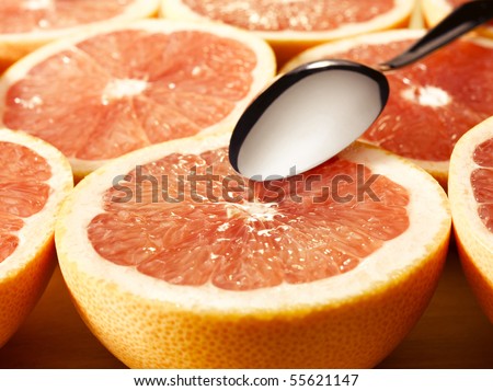 couple of delicious grapefruits with a spoon