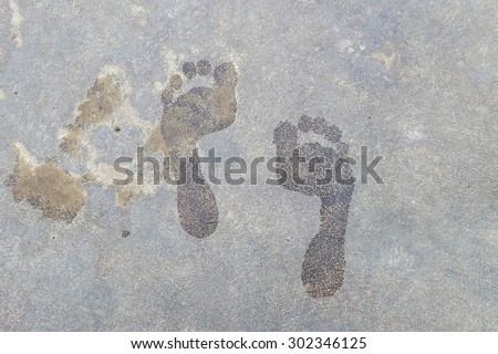 Wet floor of foot shape on cement background