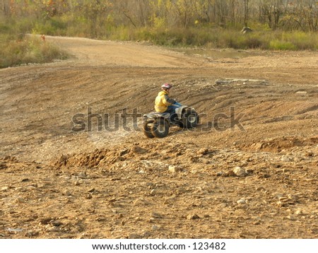Person riding all terrain vechicle.