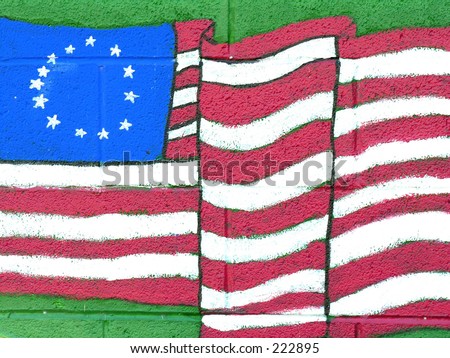 Painting on building of American flag bearing original 13 colonies