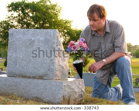 stock-photo-man-putting-flowers-on-grave-338743.jpg