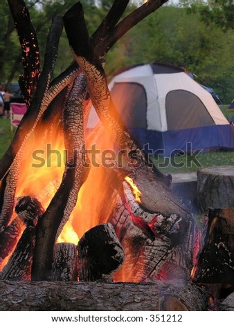 Campfire with tent in background