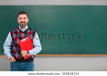 Young man teacher on green board.