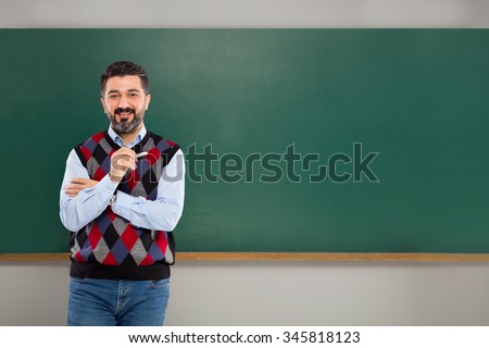 Young man teacher on green board.