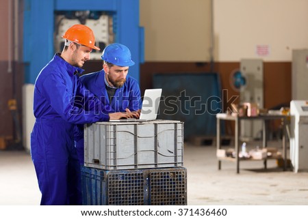Engineer and foreman in factory.