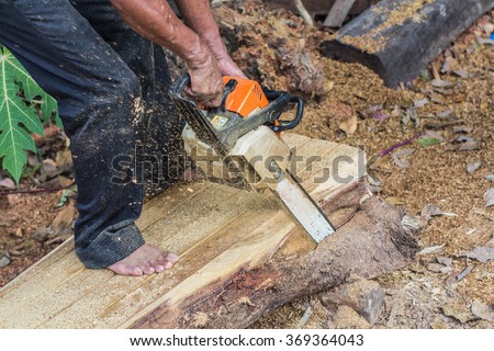 Focus carpenter sawing wood