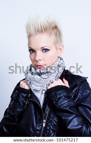 fashion model woman wearing scarf and black leather jacket on gray background - studio shot