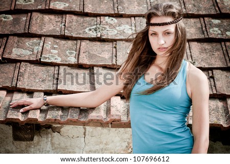 fashion woman in front of a grunge tiles  - colorized photo