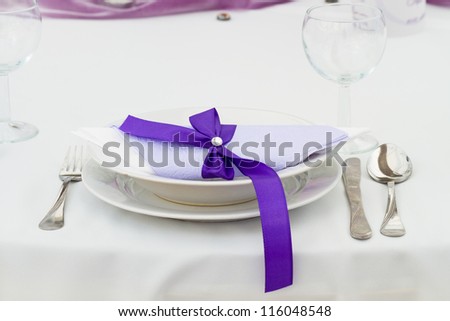 luxury place setting, purple napkin on plate
