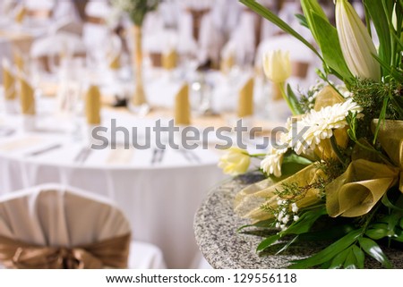 flower decoration in restaurant, wedding or another catered event table set in blurred background