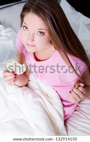 diet woman eating on her bed