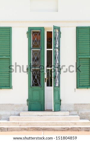 green and white door, green shutters in a white castle