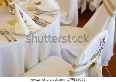 lavender flower decoration on wedding chairs cover
