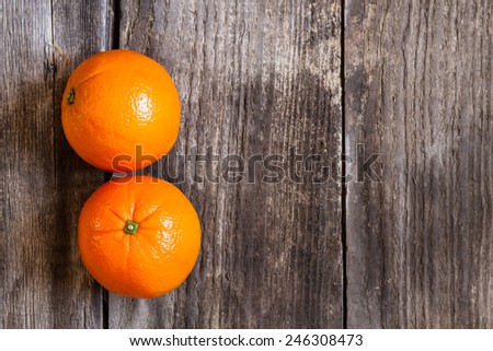 oranges on textured weathered wooden table - top view