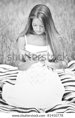 young beautiful girl with book in nature - black and white