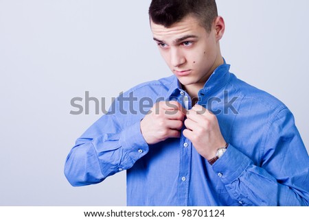 dressing up, handsome man button up his blue shirt