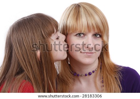 Girl is kissing woman. Daughter\'s kiss. Daughter kissing her happy mother.  Isolated on white in studio.