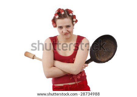 Woman in hair rollers is holding a frying pan.  Very frustrated and angry mad woman. Angry look on face. Studio, white background.