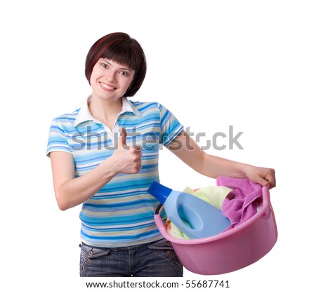 Housewife with laundry basket.  A young woman holding a basket of folded laundry. Time for laundry day.