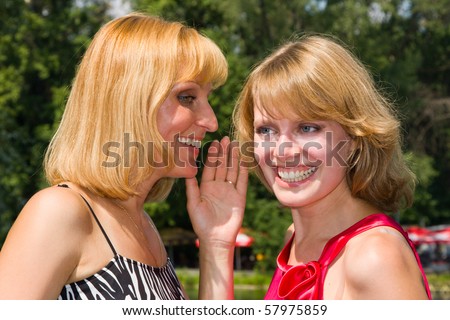 Girl telling a secret to