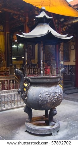 An incense burner in a traditional Chinese temple, where people burn incense and paper money to honor their families and ancestors
