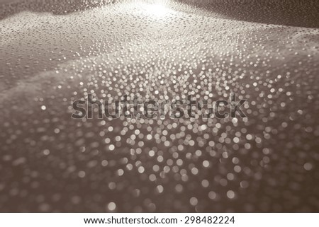 Water drops collect on top of metal a car surface