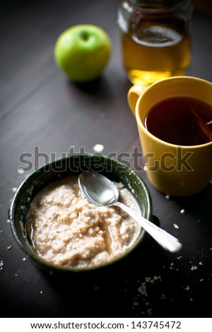 Breakfast with oatmeal, apple, honey and tea
