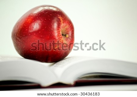 Apple and book on the white background