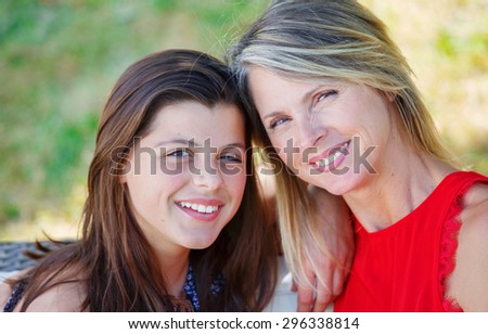 Mother and daughter hugging, smiling and sharing. Mothers day concept. Serenity and tranquility.