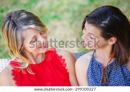Mother and daughter hugging, smiling and sharing. Mothers day concept. Serenity and tranquility.