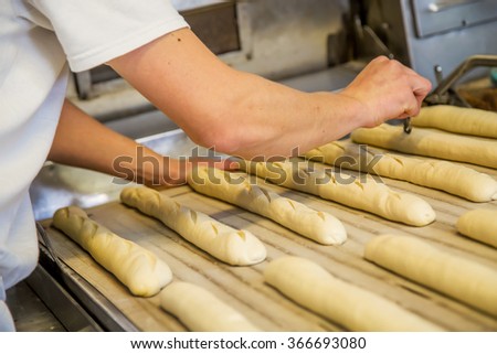 baker making bread with his hands