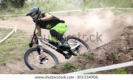 Sportsman in sportswear on a mountain bike rides on the stones in the extreme style of downhill