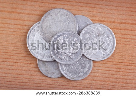 silver coins on wooden background