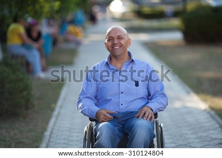 wheelchair user happy in the park
