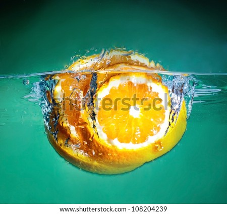 orange splash into fresh water