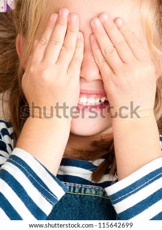 cute smiling girl with closed eyes by hands